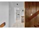 Hallway with white walls, light tile floor, and wood accents at 2922 Cocovia Way, Leesburg, FL 34748