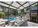 Inviting screened-in patio with comfortable seating and a view of the sparkling pool at 2922 Cocovia Way, Leesburg, FL 34748