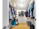 Spacious walk-in closet with ample storage, shelving, and wooden floors at 2922 Cocovia Way, Leesburg, FL 34748