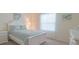 Cozy bedroom with white furniture, soft carpet, and a bright window with natural light at 3021 Beard Rd, The Villages, FL 32163