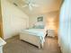 Well-lit bedroom featuring a ceiling fan, soft carpet, and a large window at 3021 Beard Rd, The Villages, FL 32163