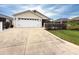 Charming one-story home with an attached two-car garage and well-maintained lawn at 3021 Beard Rd, The Villages, FL 32163