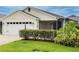 Well-maintained single Gathering home featuring an attached garage, screened in porch and manicured lawn at 3021 Beard Rd, The Villages, FL 32163