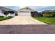 Charming single Gathering home featuring an attached garage and well-maintained landscaping at 3021 Beard Rd, The Villages, FL 32163
