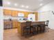 Well-equipped kitchen featuring an island, breakfast bar, and ample cabinet space at 3021 Beard Rd, The Villages, FL 32163