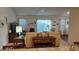 Cozy living room with comfortable sofa and large windows providing natural light at 3021 Beard Rd, The Villages, FL 32163