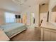Spacious bedroom featuring a ceiling fan, soft carpet, and doorway to bathroom at 3021 Beard Rd, The Villages, FL 32163