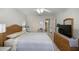 Serene primary bedroom featuring a ceiling fan, and a connecting en-suite bathroom at 3024 Burbank Ln, The Villages, FL 32162