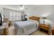 Cozy bedroom features a bed, ceiling fan, and closet space with great natural lighting from the windows at 3024 Burbank Ln, The Villages, FL 32162