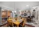 This dining room features a kitchen view, sliding door access, and a wooden table with seating for four at 3024 Burbank Ln, The Villages, FL 32162