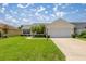 Charming single-story home with a well-manicured lawn and attached two-car garage at 3024 Burbank Ln, The Villages, FL 32162