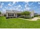 Home exterior with a manicured lawn, sidewalk and charming landscaping at 3024 Burbank Ln, The Villages, FL 32162