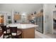 Bright kitchen features stainless steel appliances, island with seating, and light wood cabinets at 3024 Burbank Ln, The Villages, FL 32162