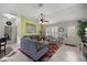 Inviting living room features tiled floors, comfortable seating, and large windows for natural light at 3024 Burbank Ln, The Villages, FL 32162