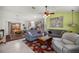 Open concept living room and dining area with comfortable sofas and tiled floors and a connecting kitchen at 3024 Burbank Ln, The Villages, FL 32162