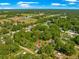 Wide aerial view of property featuring lush surroundings and an arrow indicating the home's location in a tranquil setting at 3445 Se 139Th Ln, Summerfield, FL 34491
