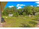 Large backyard with well-maintained lawn and trees at 3445 Se 139Th Ln, Summerfield, FL 34491