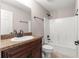 Bathroom featuring a shower with a tub, toilet, dark vanity, and a sink at 3445 Se 139Th Ln, Summerfield, FL 34491