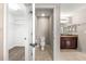 Bright bathroom featuring a toilet, vanity with sink, and walk-in closet with carpeted floor at 3445 Se 139Th Ln, Summerfield, FL 34491