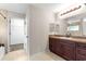 Bathroom featuring tiled flooring, a dark vanity, and a walk-in closet at 3445 Se 139Th Ln, Summerfield, FL 34491
