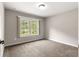 Bright bedroom featuring carpet flooring and a window with a peaceful view at 3445 Se 139Th Ln, Summerfield, FL 34491