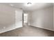 Neutral bedroom with a ceiling light, neutral walls, carpeted floors, and white doors at 3445 Se 139Th Ln, Summerfield, FL 34491