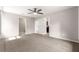 Spacious bedroom showcasing carpeted floors, a ceiling fan, and multiple doorways at 3445 Se 139Th Ln, Summerfield, FL 34491
