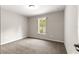 Neutral bedroom with a window looking out at trees and carpeted flooring at 3445 Se 139Th Ln, Summerfield, FL 34491