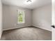 Neutral bedroom with a window offering a view of the green landscaping at 3445 Se 139Th Ln, Summerfield, FL 34491