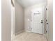 Light-filled entryway featuring neutral paint and ceramic tile flooring at 3445 Se 139Th Ln, Summerfield, FL 34491
