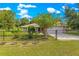 Home with fenced front yard featuring manicured lawn, trees, and a driveway at 3445 Se 139Th Ln, Summerfield, FL 34491