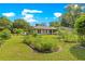 Charming home with well-manicured front yard, colorful flower beds, and lush green lawn at 3445 Se 139Th Ln, Summerfield, FL 34491