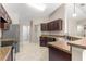 Traditional kitchen with stainless steel appliances, tiled floors, and tan granite countertops at 3445 Se 139Th Ln, Summerfield, FL 34491