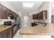 Spacious kitchen featuring tiled floors, stainless steel appliances and granite countertops at 3445 Se 139Th Ln, Summerfield, FL 34491