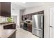 Open kitchen design featuring tile floors and modern stainless-steel appliances at 3445 Se 139Th Ln, Summerfield, FL 34491