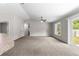 Open living room with neutral paint, plush carpeting, and sliding glass door at 3445 Se 139Th Ln, Summerfield, FL 34491