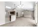 Open-concept living room with vaulted ceilings, neutral paint and open floorplan to kitchen at 3445 Se 139Th Ln, Summerfield, FL 34491