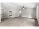 Bright, spacious living room with high ceilings, neutral paint, and plush carpeting at 3445 Se 139Th Ln, Summerfield, FL 34491
