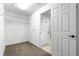 Spacious walk-in closet with carpet flooring, ample shelving, and access to the bathroom at 3445 Se 139Th Ln, Summerfield, FL 34491