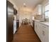 Stylish kitchen with white cabinets, stainless steel appliances, and view into the dining area at 3529 Sw 150Th Ct, Dunnellon, FL 34432