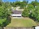 Aerial view of expansive backyard, featuring a screened in porch and wooden fence at 4085 Ne 17Th Ave, Ocala, FL 34479
