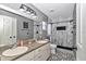 Updated bathroom features dual sinks, and a stylish shower with black and white marble-patterned tile at 4085 Ne 17Th Ave, Ocala, FL 34479