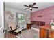 Charming Bedroom with pink accent wall, comfortable glider chair, and ample natural light at 4085 Ne 17Th Ave, Ocala, FL 34479