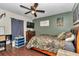 Comfortable bedroom features wood-look tile flooring, camouflage decor, and a ceiling fan at 4085 Ne 17Th Ave, Ocala, FL 34479