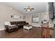Comfortable living room featuring dark wood floors, ceiling fan, and natural light at 4085 Ne 17Th Ave, Ocala, FL 34479