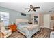 Relaxing primary bedroom with a plush bed, hardwood floors, and ample natural light at 4085 Ne 17Th Ave, Ocala, FL 34479