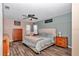 Comfortable primary bedroom with a ceiling fan, hardwood floors, and neutral color scheme at 4085 Ne 17Th Ave, Ocala, FL 34479