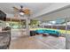 Relaxing covered patio with comfortable seating, ceiling fan, and views of the backyard at 4085 Ne 17Th Ave, Ocala, FL 34479