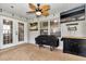 Enclosed patio with ceiling fan, outdoor TV, and grill for backyard entertainment at 4085 Ne 17Th Ave, Ocala, FL 34479