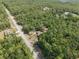 A high-altitude shot with the home nestled among lush trees in an outdoor setting at 4467 Sw Channel Heights Ct, Dunnellon, FL 34431